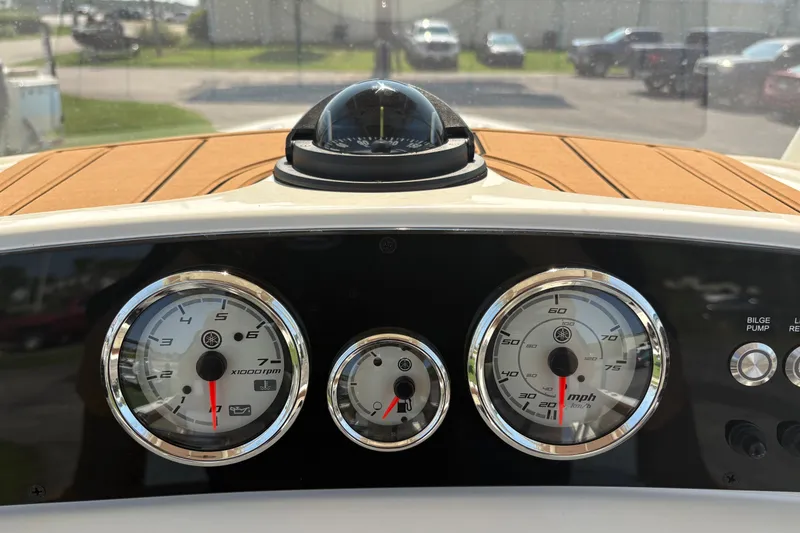 Slide: The Image of Dashboard of a 2027 Pioneer 202 Islander boat with gauges and compass. - 22