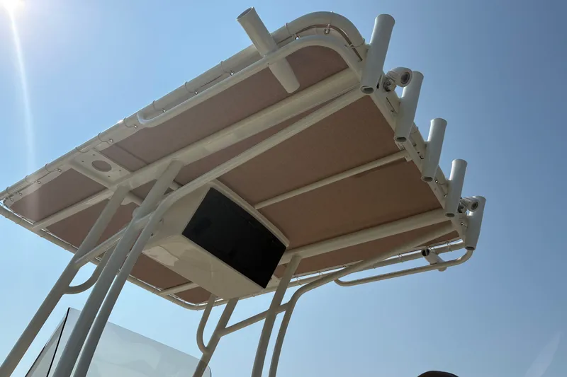 Slide: The Image of T-top of 2027 Pioneer 202 Islander boat under clear blue sky. - 14