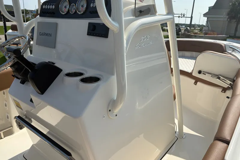 Slide: The Image of 2027 Pioneer 202 Islander boat console with Garmin navigation and cup holders. - 24