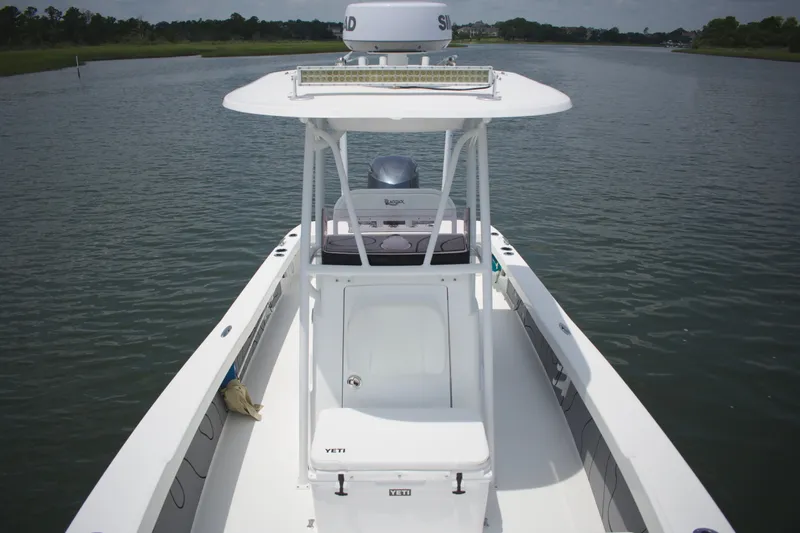 Slide: The Image of 2020 BlackJack 256 Coastal boat on calm water, featuring a spacious deck and modern design. - 12