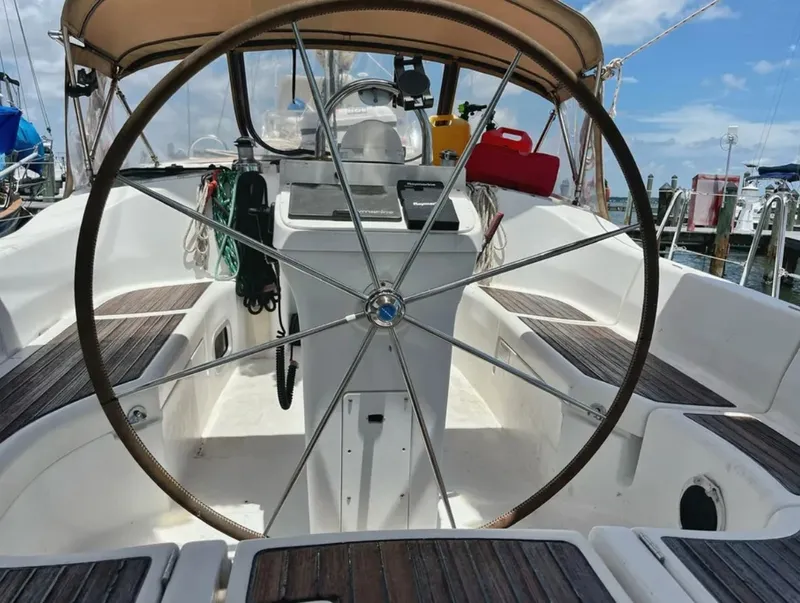 Slide: The Image of The image shows the cockpit of a 2005 Beneteau 423 with a large steering wheel. - 3
