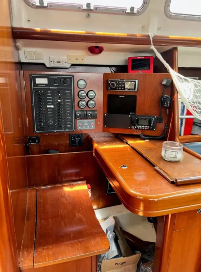 Slide: The Image of Interior of a 2005 Beneteau 423 with wooden table and navigation instruments. - 18
