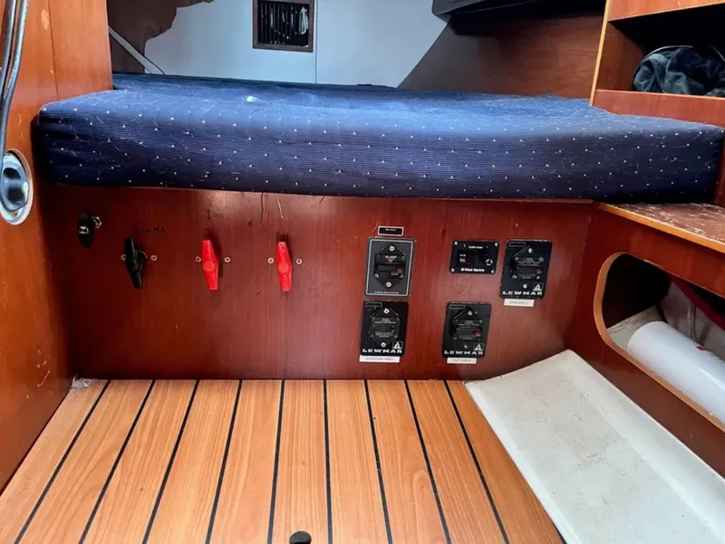 Slide: The Image of Interior of a 2005 Beneteau 423 with wood flooring and control panels. - 13