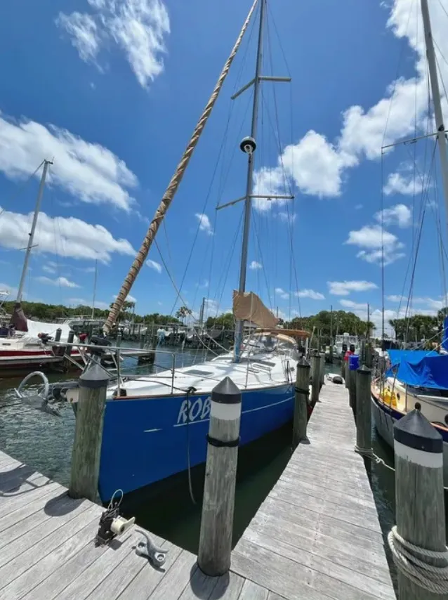 The Image of 2005 Beneteau 423 sailboat docked, featuring a blue hull and tall masts. - 0