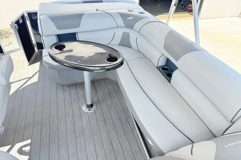 Slide: The Image of 2018 Starcraft Cruise 220 boat interior with gray seating and a central table. - 17