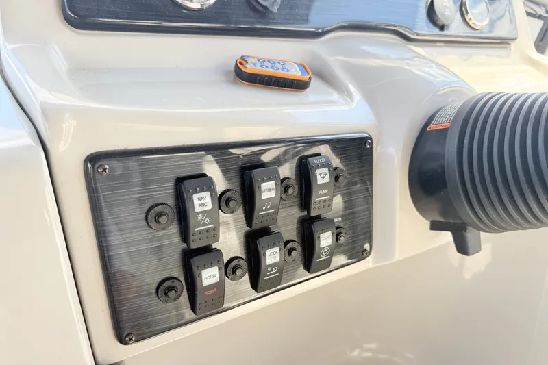 Slide: The Image of Control panel of a 2018 Starcraft Cruise 220 boat with labeled switches. - 12