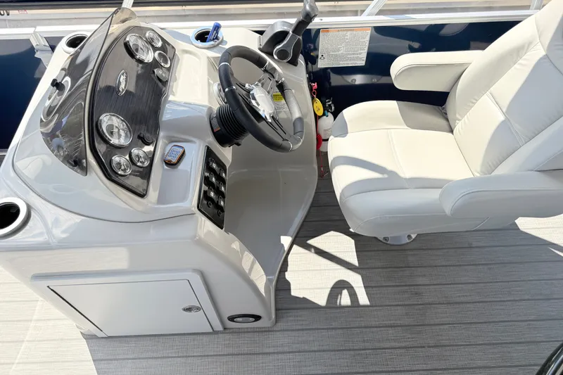 Slide: The Image of 2018 Starcraft Cruise 220 boat helm with steering wheel and captain's chair. - 18