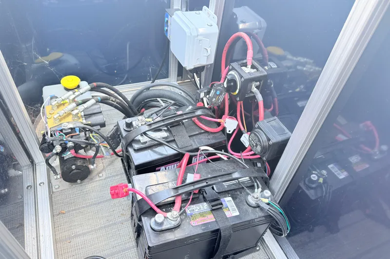 Slide: The Image of Electrical components and batteries inside a 2018 Starcraft Cruise 220 boat. - 11