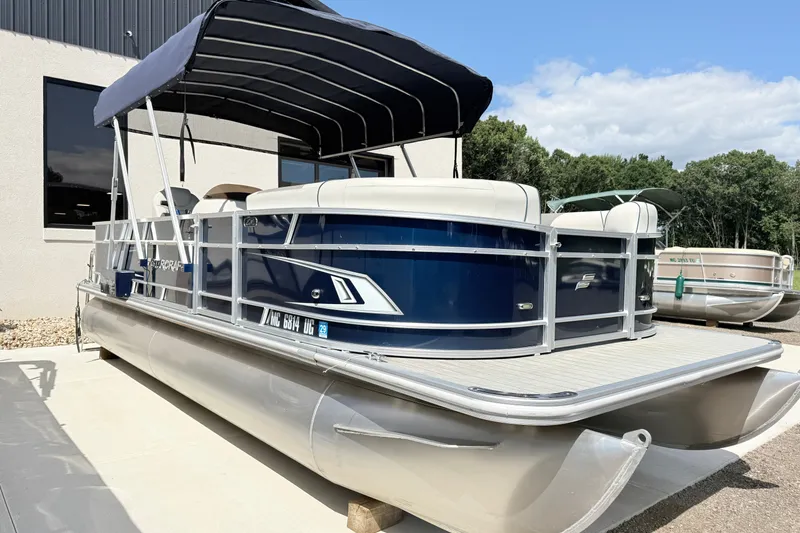 Slide: The Image of 2018 Starcraft Cruise 220 pontoon boat with canopy, parked outdoors on a sunny day. - 3