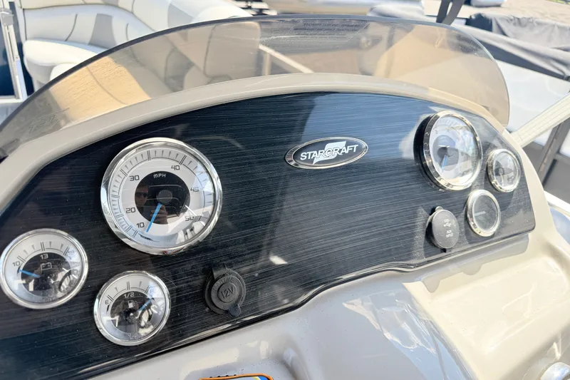 Slide: The Image of Dashboard of a 2018 Starcraft Cruise 220 boat with speedometer and gauges. - 13