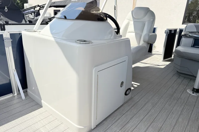 Slide: The Image of 2018 Starcraft Cruise 220 boat interior with helm and seating area. - 6