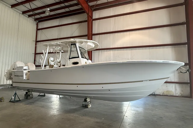 The Image of 2027 Regulator 31 boat in a spacious indoor storage facility. - 1