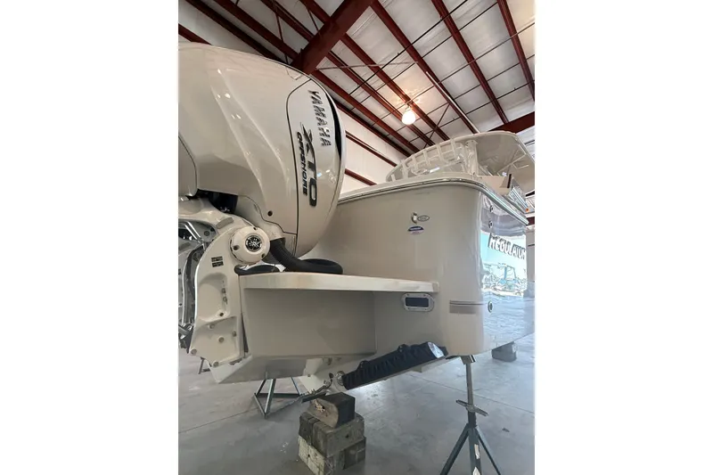 Slide: The Image of 2027 Regulator 31 boat with Yamaha XTO engine in a warehouse setting. - 3