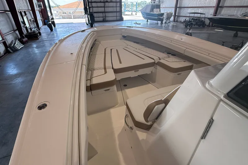 Slide: The Image of 2027 Regulator 31 boat interior with cushioned seating in a spacious garage. - 4
