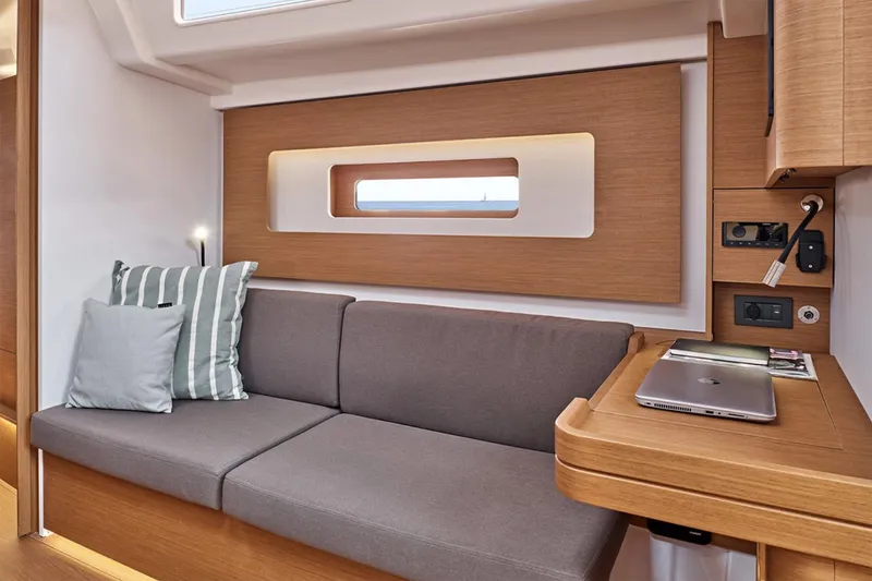 Slide: The Image of Manufacturer Provided Image: Modern interior of 2026 Beneteau First 44 yacht with cozy seating and workspace. - 5