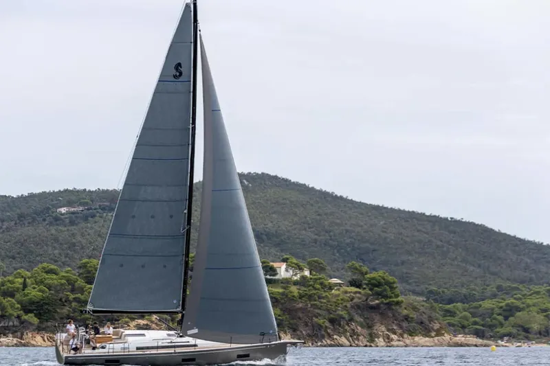 Slide: The Image of Manufacturer Provided Image: 2026 Beneteau First 44 sailboat cruising near a scenic coastline. - 2