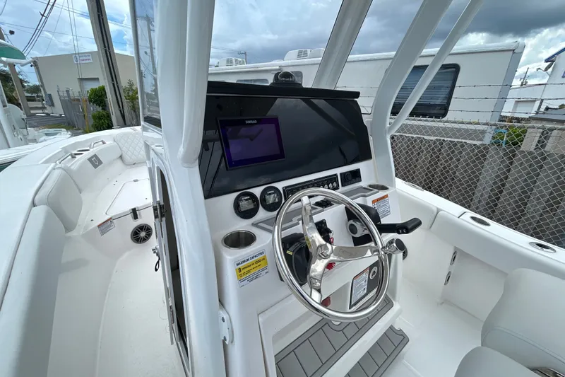 Slide: The Image of 2025 Sea Fox 228 Commander boat cockpit with steering wheel and navigation display. - 1