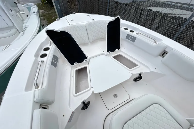 Slide: The Image of 2025 Sea Fox 228 Commander boat interior with white seating and storage compartments. - 5
