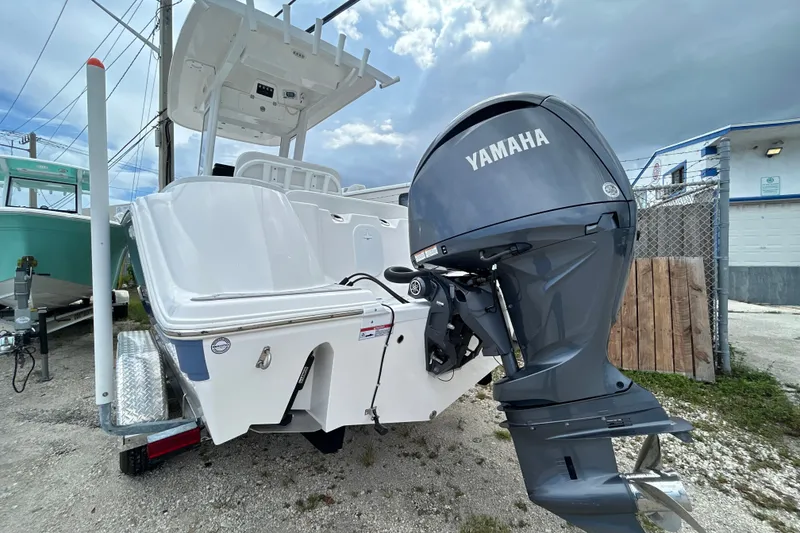 Slide: The Image of 2025 Sea Fox 228 Commander boat with Yamaha outboard motor, parked on a trailer. - 11