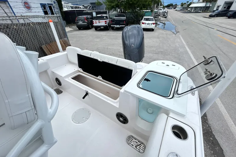 Slide: The Image of 2025 Sea Fox 228 Commander boat deck with storage compartments and engine view. - 3