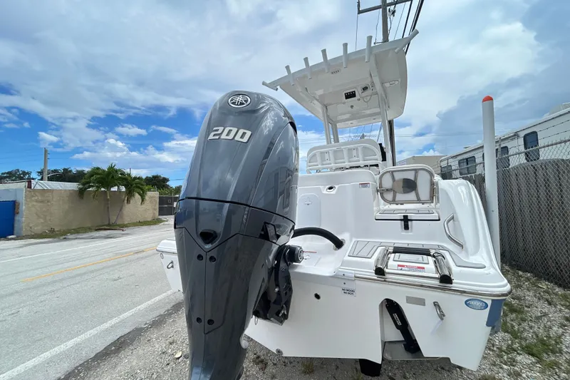 Slide: The Image of 2025 Sea Fox 228 Commander boat with powerful 200 horsepower engine, parked outdoors. - 10