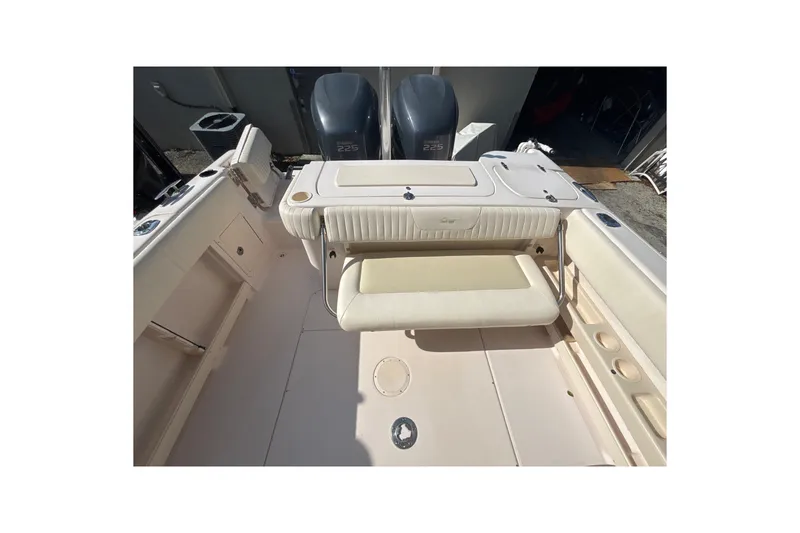 Slide: The Image of 2008 Grady-White Freedom 275 boat interior with seating and dual engines. - 5