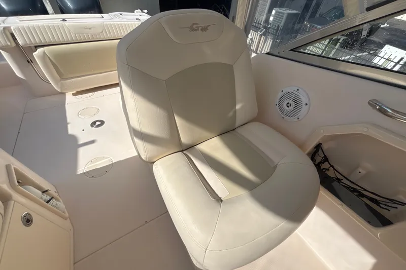 Slide: The Image of Grady-White Freedom 275 boat interior, featuring a comfortable beige seat and speaker, 2008 model. - 9