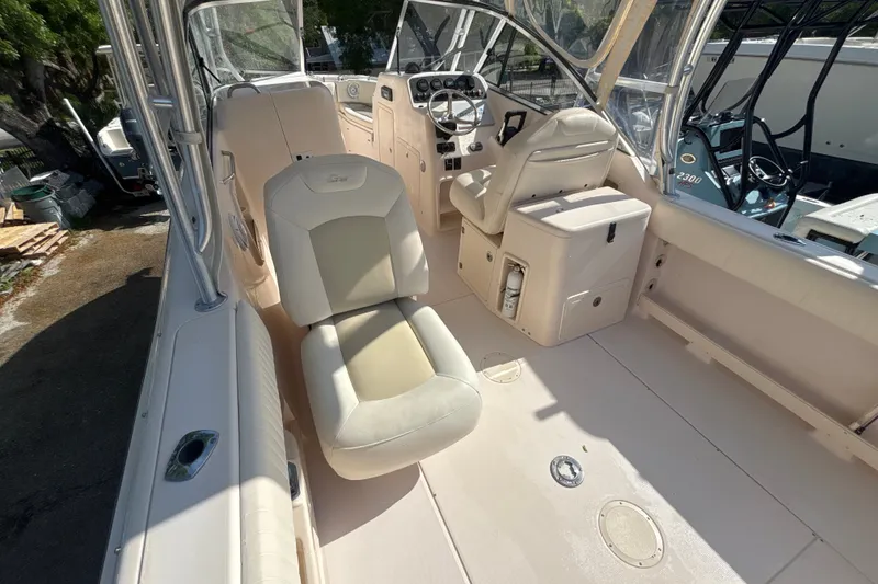 Slide: The Image of 2008 Grady-White Freedom 275 boat interior with helm and seating area. - 8