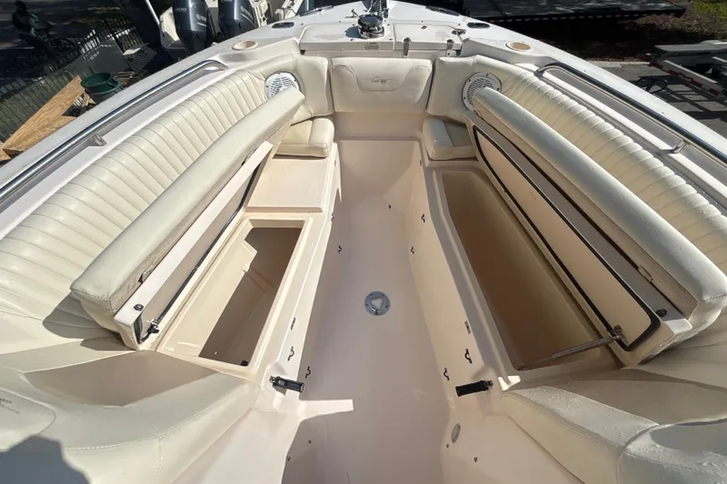 Slide: The Image of 2008 Grady-White Freedom 275 boat interior with open storage compartments and cushioned seating. - 14