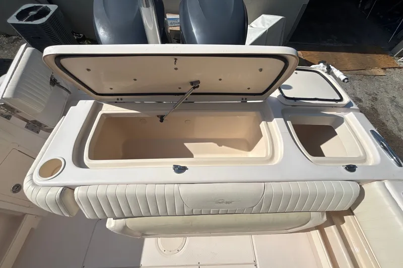Slide: The Image of 2008 Grady-White Freedom 275 boat storage compartments open, showcasing spacious interior. - 6