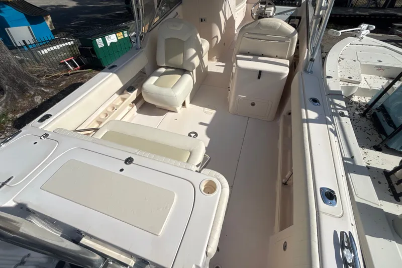 Slide: The Image of 2008 Grady-White Freedom 275 boat interior with seating and steering console. - 4