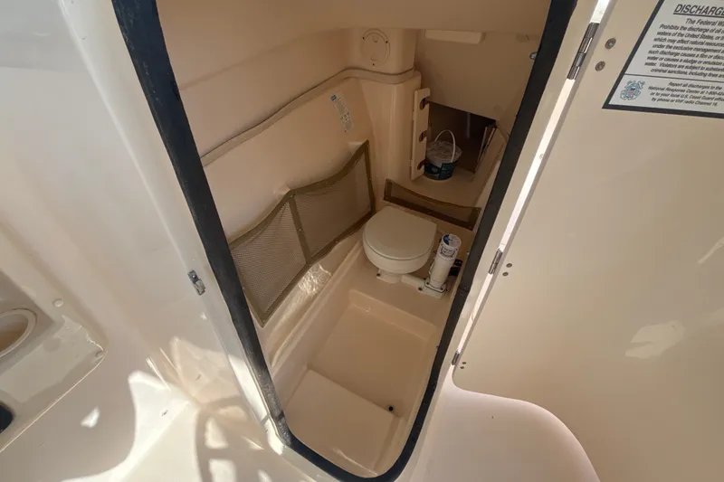 Slide: The Image of Interior view of 2008 Grady-White Freedom 275 boat bathroom with toilet and storage. - 12