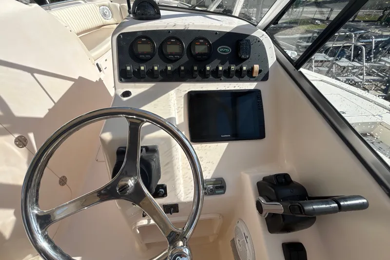 Slide: The Image of Grady-White Freedom 275 boat dashboard with steering wheel and control panel, 2008 model. - 11