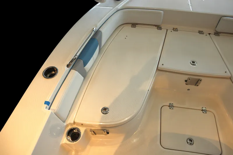 Slide: The Image of 2026 Robalo 226 Cayman boat deck with storage compartments and cup holders. - 6