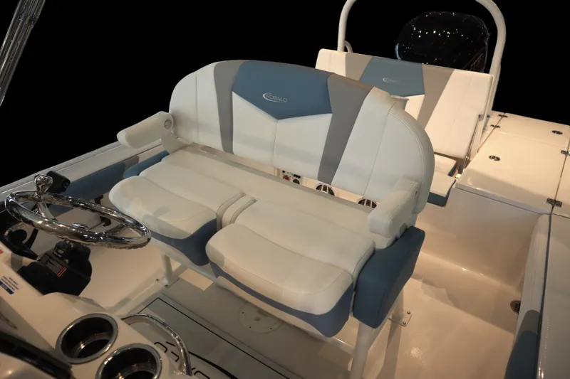 Slide: The Image of 2026 Robalo 226 Cayman boat interior with dual seating and steering wheel. - 16