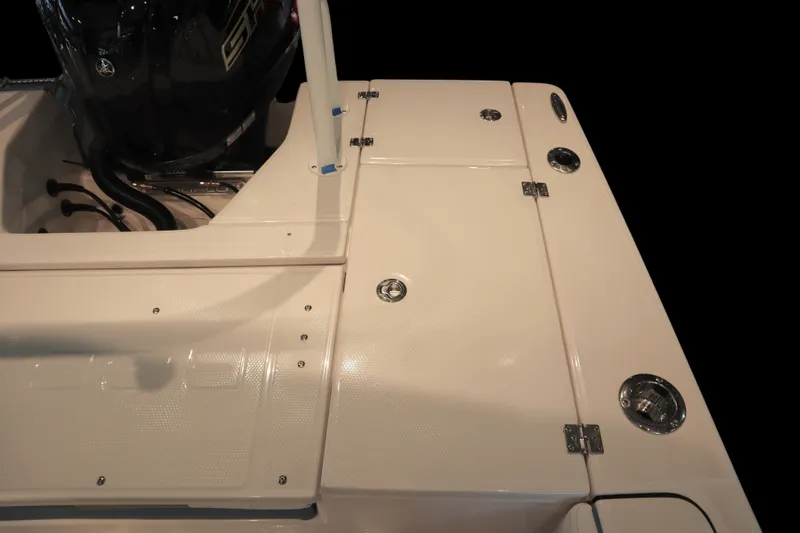 Slide: The Image of 2026 Robalo 226 Cayman boat deck with engine and storage compartments. - 26