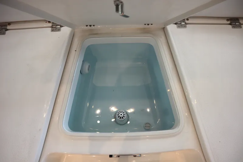 Slide: The Image of Livewell compartment on 2026 Robalo 226 Cayman boat, filled with water. - 8