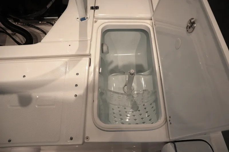 Slide: The Image of 2026 Robalo 226 Cayman boat livewell with open lid, showcasing interior design. - 27