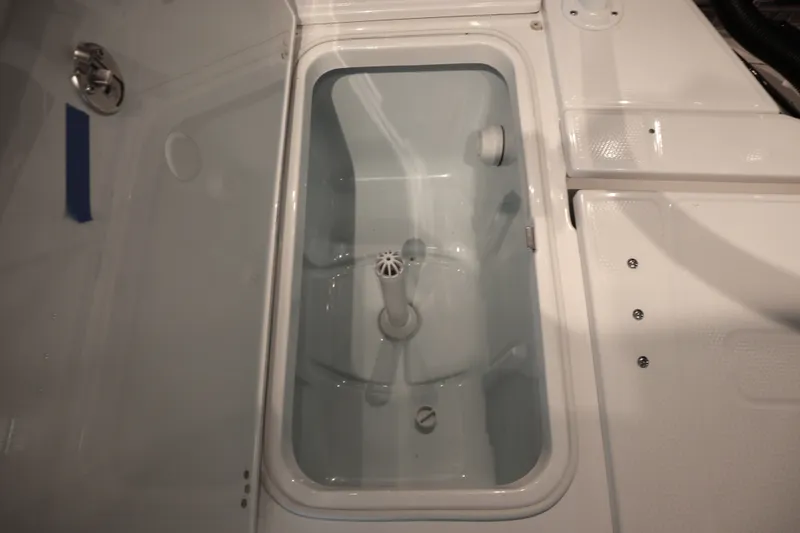 Slide: The Image of Livewell compartment in 2026 Robalo 226 Cayman boat, featuring a clean, white interior. - 30