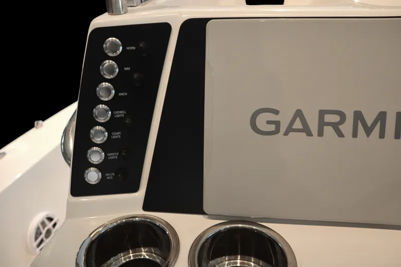 Slide: The Image of Control panel of 2026 Robalo 226 Cayman boat with Garmin display and switches. - 19