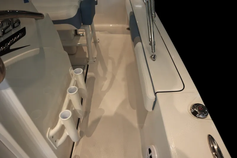 Slide: The Image of Interior view of 2026 Robalo 226 Cayman boat, featuring rod holders and seating. - 15