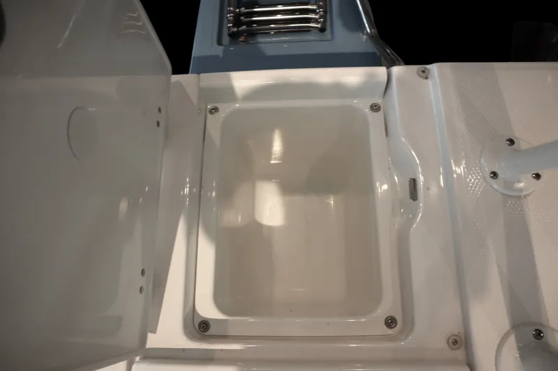 Slide: The Image of 2026 Robalo 226 Cayman boat storage compartment, open and empty, showcasing interior design. - 31