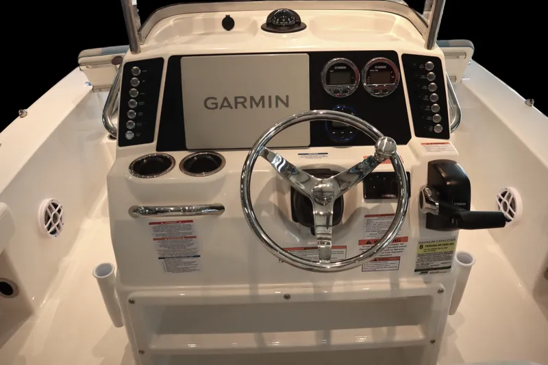 Slide: The Image of 2026 Robalo 226 Cayman boat dashboard with Garmin navigation system and steering wheel. - 17