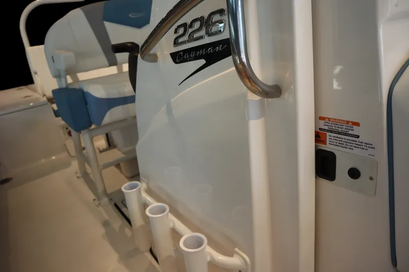 Slide: The Image of 2026 Robalo 226 Cayman boat interior with seating and rod holders. - 14