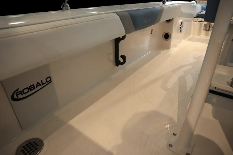 Slide: The Image of 2026 Robalo 226 Cayman boat interior with logo and seating area. - 22