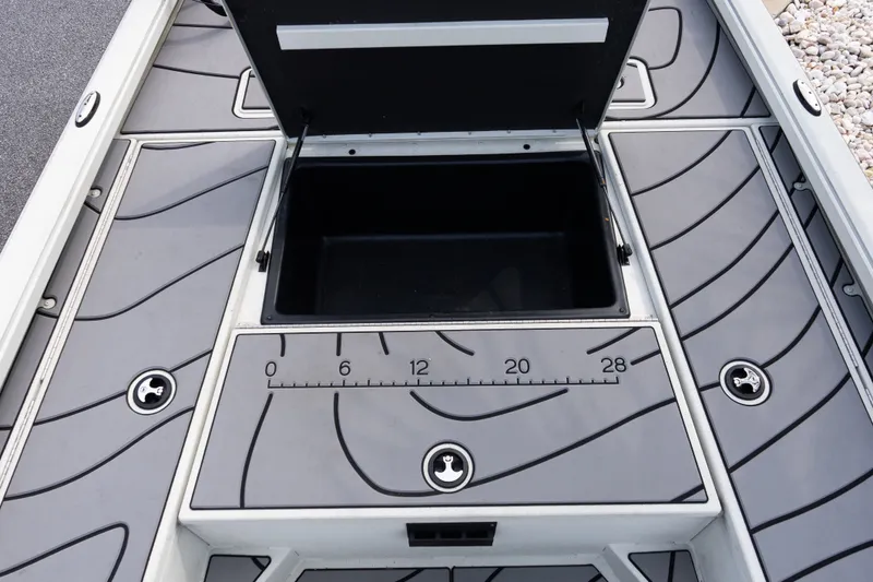 Slide: The Image of 2022 Ranger RB200 boat deck with open storage compartment and measurement markings. - 13