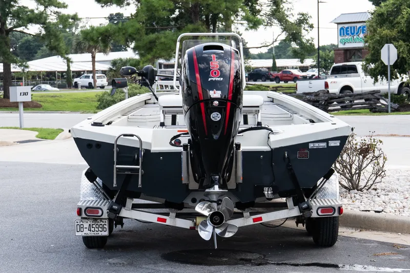 Slide: The Image of 2022 Ranger RB200 boat with 150 horsepower engine, parked outdoors. - 5