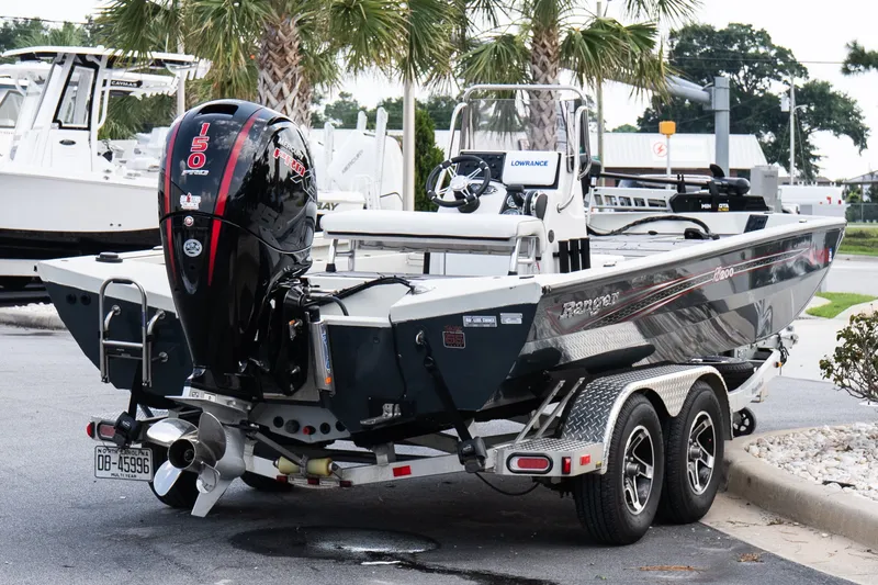 Slide: The Image of 2022 Ranger RB200 boat on trailer with powerful outboard motor, parked outdoors. - 6