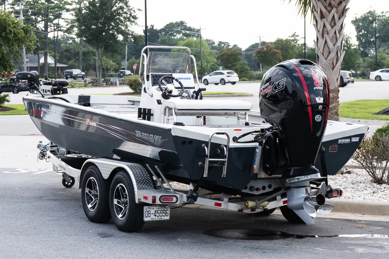 Slide: The Image of 2022 Ranger RB200 boat on trailer with powerful outboard motor in parking lot. - 4