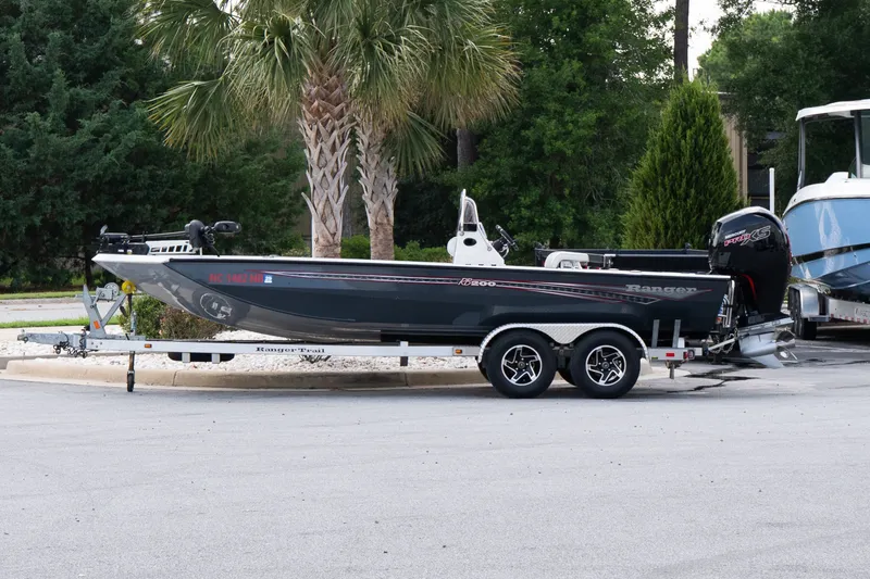 The Image of 2022 Ranger RB200 boat on trailer, parked near palm trees. - 1